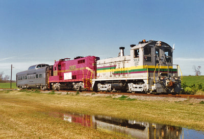 New Orleans Lower Coast parent company RailTex leased private car Silver Palace to use on a series of employee and customer passenger special trains on its various properties across the country. In January 1995 the car was in use on the NOLR. Here we see an NOLR passenger special making a photo run-by at Jesuit Bend along the west bank of the Mississippi River - Jesuit Bend, LA - 1-8-1995 - C.M.Palmieri Photo.